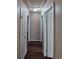 Hallway view featuring wood floors and multiple doors leading to rooms at 3735 S Lewiston St, Aurora, CO 80013