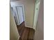 Hallway view featuring wood floors and multiple doorways at 3735 S Lewiston St, Aurora, CO 80013
