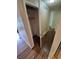 Hallway view featuring wood floors with an open closet with shelving and rod at 3735 S Lewiston St, Aurora, CO 80013