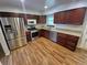 Updated kitchen featuring stainless appliances, granite counters, and dark wood cabinets at 3735 S Lewiston St, Aurora, CO 80013