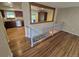 Open concept living area with wood floors leading into the kitchen with stainless appliances at 3735 S Lewiston St, Aurora, CO 80013