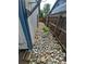 Narrow side yard featuring decorative rock landscaping and wooden fence at 3735 S Lewiston St, Aurora, CO 80013