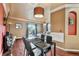 Open dining space adjacent to the living room featuring hardwood floors and sliding glass doors to the outside at 12770 Jasmine Ct, Thornton, CO 80602
