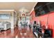 Open dining area with hardwood floors, modern black table, and an open layout to the living area at 12770 Jasmine Ct, Thornton, CO 80602
