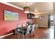 Contemporary dining area featuring dark table set, hardwood floors, and modern lighting fixture at 12770 Jasmine Ct, Thornton, CO 80602