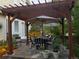 Cozy outdoor patio with a pergola, striped umbrellas, and comfortable seating at 3183 W 114Th Loop, Westminster, CO 80031