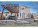 Charming backyard patio with a pergola, a stone seating area, and an outdoor table with chairs at 3183 W 114Th Loop, Westminster, CO 80031