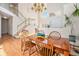 Elegant dining room with high ceilings, a chandelier, a wooden table, and a staircase at 3183 W 114Th Loop, Westminster, CO 80031