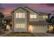 Charming two-story home with a brick facade and a well-maintained lawn at dusk at 3183 W 114Th Loop, Westminster, CO 80031