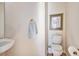 Cozy half-bathroom featuring a stylish sink, toilet, towel holder, and framed picture on the wall at 3183 W 114Th Loop, Westminster, CO 80031