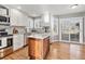 Bright kitchen featuring a center island, stainless appliances, and a sliding patio door at 3183 W 114Th Loop, Westminster, CO 80031