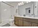 Clean bathroom with double vanity, bathtub, and tiled shower at 9275 Merino Ct # A, Littleton, CO 80125