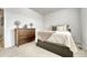 Bright bedroom with carpeted floor, dresser, and comfortable bed at 9275 Merino Ct # A, Littleton, CO 80125