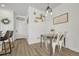 Small dining area with white metal chairs and a farmhouse-style table at 9275 Merino Ct # A, Littleton, CO 80125