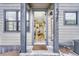 Open front door reveals interior with a view through to kitchen and living areas at 9275 Merino Ct # A, Littleton, CO 80125