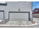 Attached garage with gray door and ample space at 9275 Merino Ct # A, Littleton, CO 80125