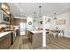 Modern kitchen with island, stainless steel appliances, and dining area at 9275 Merino Ct # A, Littleton, CO 80125