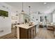 Modern kitchen with island, dark cabinets, quartz countertops, and stainless appliances at 9275 Merino Ct # A, Littleton, CO 80125