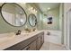 Elegant bathroom with double vanity, soaking tub and walk-in shower at 9275 Merino Ct # A, Littleton, CO 80125