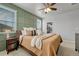 Main bedroom with wood-toned furniture and neutral bedding at 9275 Merino Ct # A, Littleton, CO 80125