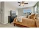 Main bedroom with a dresser, TV and neutral bedding at 9275 Merino Ct # A, Littleton, CO 80125