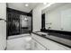 Bathroom with black marble and modern vanity at 1770 Akron St, Aurora, CO 80010