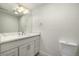 White bathroom vanity with quartz countertop and modern fixtures at 1770 Akron St, Aurora, CO 80010