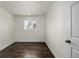 Bright bedroom featuring dark hardwood floors and neutral walls at 1770 Akron St, Aurora, CO 80010