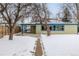 House front yard with snowy landscaping at 1770 Akron St, Aurora, CO 80010