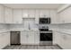 Updated kitchen featuring white cabinets and quartz countertops at 1770 Akron St, Aurora, CO 80010