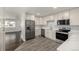 Bright kitchen boasts stainless steel appliances and white cabinetry at 1770 Akron St, Aurora, CO 80010