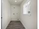 Laundry room with grey vinyl flooring and a window at 1770 Akron St, Aurora, CO 80010