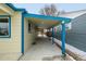 Covered side porch with blue accents and a concrete floor at 1770 Akron St, Aurora, CO 80010