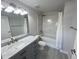 Modern bathroom with white marble sink, new fixtures, and shower-tub combination at 100 Park Ave # 1405, Denver, CO 80205