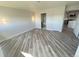 Bright, open bedroom with new floors, leading to modern bathroom and kitchen at 100 Park Ave # 1405, Denver, CO 80205