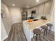 Modern kitchen featuring gray cabinetry, stainless steel appliances, and quartz countertops with seating at 100 Park Ave # 1405, Denver, CO 80205