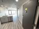 Modern kitchen with stainless steel appliances and wood-look floors at 100 Park Ave # 1405, Denver, CO 80205