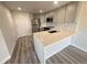 Modern kitchen featuring stainless appliances, quartz counters, and gray cabinets at 100 Park Ave # 1405, Denver, CO 80205