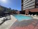 A serene pool area, complete with lounge chairs for relaxing by the shimmering water at 100 Park Ave # 1405, Denver, CO 80205