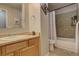 Bright bathroom featuring a vanity with storage and a shower over tub combination with tile surround at 841 Crisman Dr # 9, Longmont, CO 80501