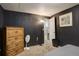 Bedroom featuring dark walls, a wooden dresser, and carpeted floors, creating a warm, comfortable space at 841 Crisman Dr # 9, Longmont, CO 80501