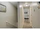 Hallway leading to a bedroom, featuring neutral wall color, carpeted floor, and ample lighting at 841 Crisman Dr # 9, Longmont, CO 80501