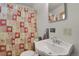 Bathroom with pedestal sink, shower/tub combo, and patterned curtain at 5567 E Asbury Ave, Denver, CO 80222