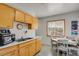 Kitchen with wood cabinets, a double sink, and a small dining area at 5567 E Asbury Ave, Denver, CO 80222