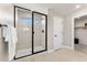 Bathroom with black framed glass shower door and a white tiled walls at 3353 N Catawba Way, Aurora, CO 80019