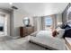 Well-lit bedroom with a large window, round mirror, and comfortable furnishings, showcasing modern style at 3353 N Catawba Way, Aurora, CO 80019