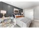 Comfortable bedroom with modern decor, gray accent wall, study desk, and natural light at 3353 N Catawba Way, Aurora, CO 80019