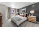 Bedroom with a wooden panel accent wall, large window, and a neutral color palette at 3353 N Catawba Way, Aurora, CO 80019