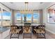 Bright dining room with modern chandelier, large windows, and seating for eight at 3353 N Catawba Way, Aurora, CO 80019