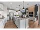 A spacious kitchen with a large island, stainless steel appliances, and an open view to the living area at 3353 N Catawba Way, Aurora, CO 80019